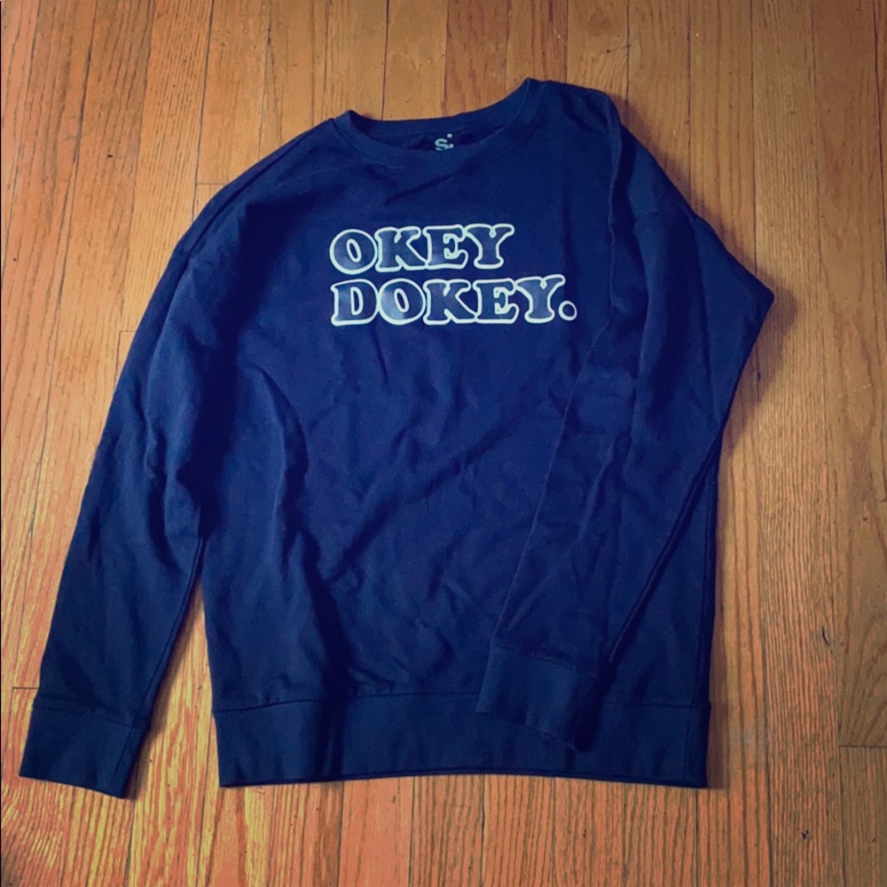Blue sweatshirt “okey dokey.”